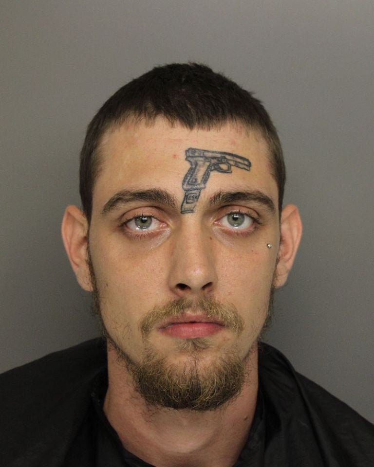 guy-with-gun-tattoo-on-his-face.jpg